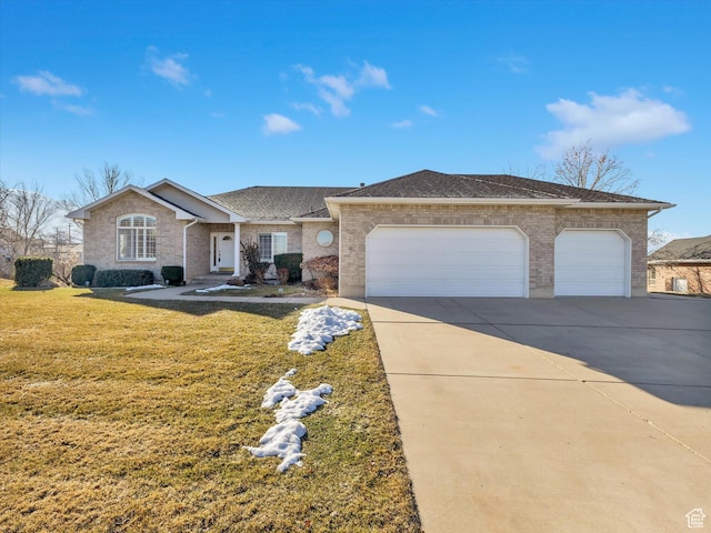 ranch-style house featuring a garage, brick siding, concrete driveway, and a front yard