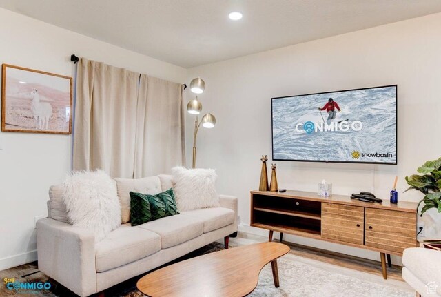 living room with wood finished floors and recessed lighting