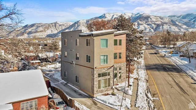 snow covered building featuring a mountain view