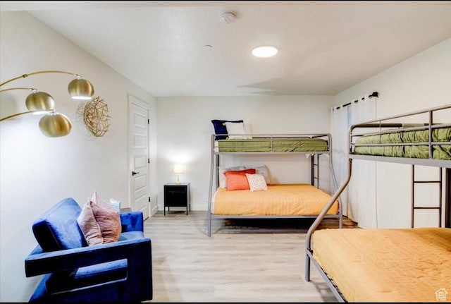 bedroom with baseboards and wood finished floors