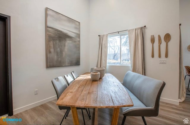 dining area with wood finished floors and baseboards