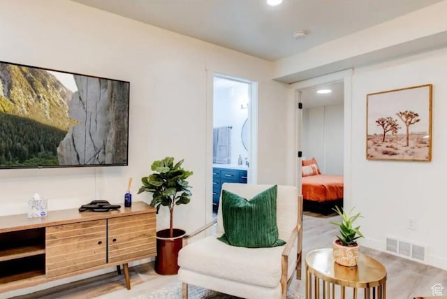 sitting room with visible vents and wood finished floors
