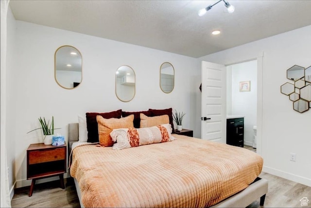 bedroom featuring baseboards and light wood-style floors