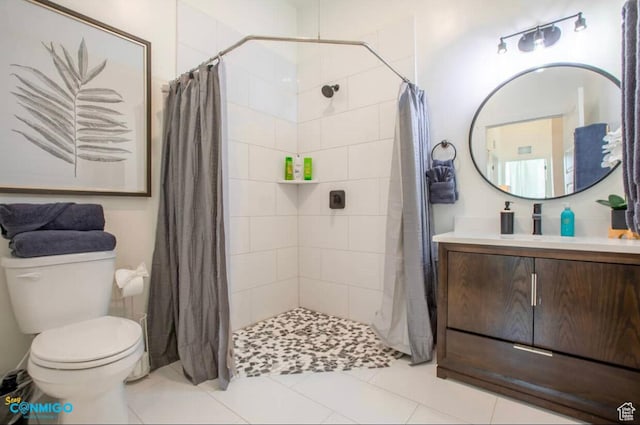 full bathroom with tiled shower, tile patterned flooring, vanity, and toilet