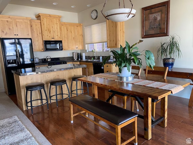 3435 Big Piney Dr, Eden, UT 84310 - kitchen featuring black appliances, light brown cabinets, a kitchen island, and dark wood-type flooring
