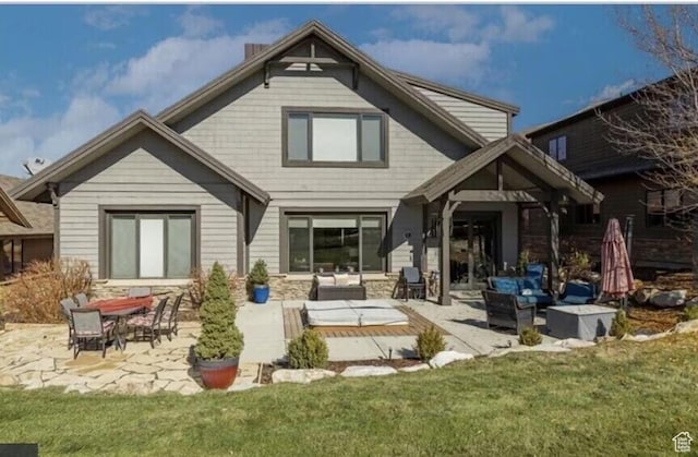 3435 Big Piney Dr, Eden, UT 84310 - back of property featuring a patio area, a yard, and outdoor lounge area