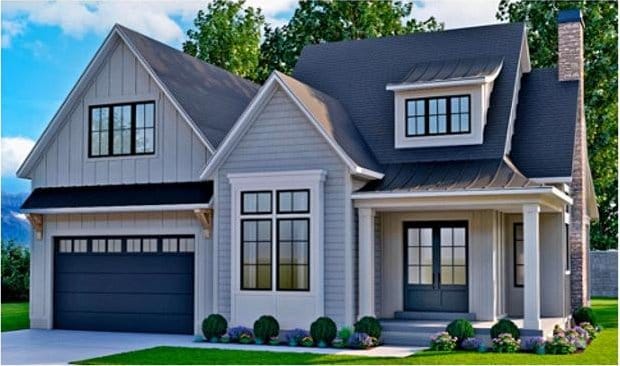 modern farmhouse style home with a chimney, an attached garage, board and batten siding, a standing seam roof, and metal roof