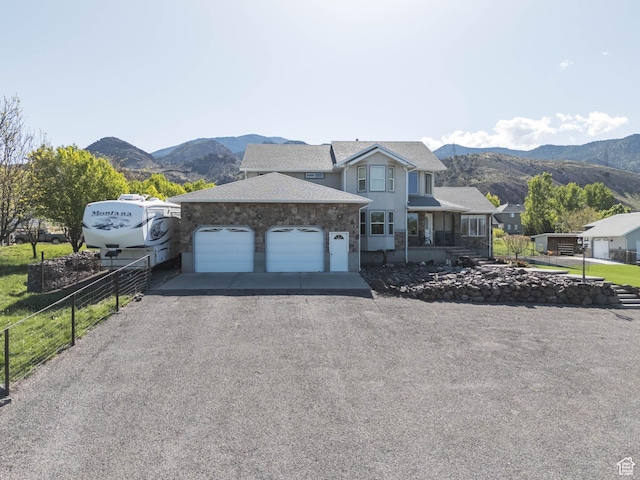 315 S 300 E, Monroe, UT 84754 - view of front of home with fence, an attached garage, a mountain view, driveway, and roof with shingles