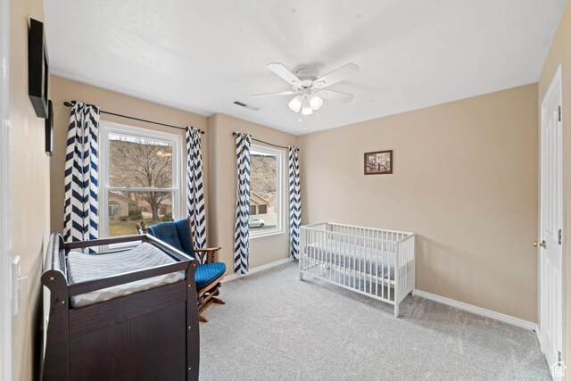 187 N Stone Mountain Dr, St George, UT 84770 - carpeted bedroom with baseboards, a nursery area, and a ceiling fan