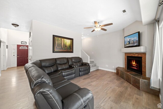 187 N Stone Mountain Dr, St George, UT 84770 - living area with light wood finished floors, a fireplace, ceiling fan, stairs, and baseboards