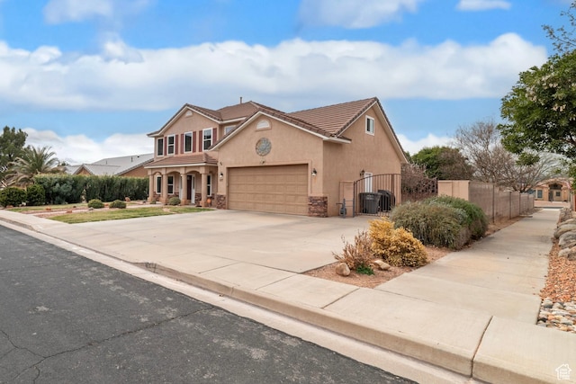 187 N Stone Mountain Dr, St George, UT 84770 - traditional home with a tiled roof, stucco siding, a garage, a gate, and concrete driveway