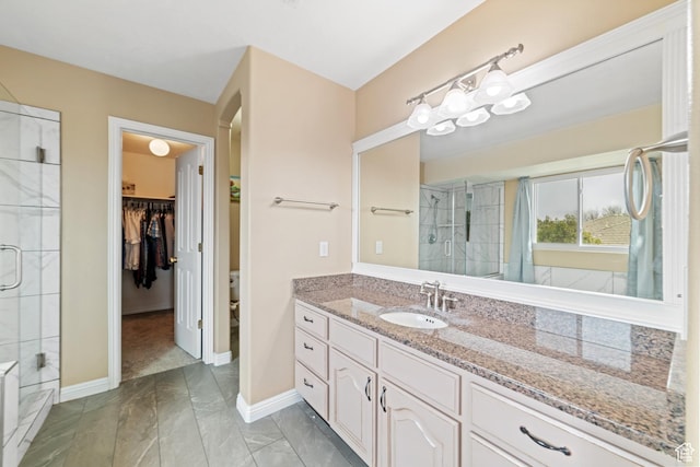 187 N Stone Mountain Dr, St George, UT 84770 - bathroom featuring tiled shower, vanity, marble finish floors, and baseboards