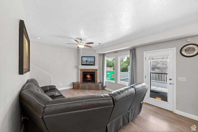 187 N Stone Mountain Dr, St George, UT 84770 - living area featuring light wood finished floors, a tile fireplace, a ceiling fan, and baseboards