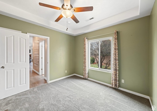 187 N Stone Mountain Dr, St George, UT 84770 - unfurnished bedroom featuring carpet, a tray ceiling, baseboards, and a ceiling fan
