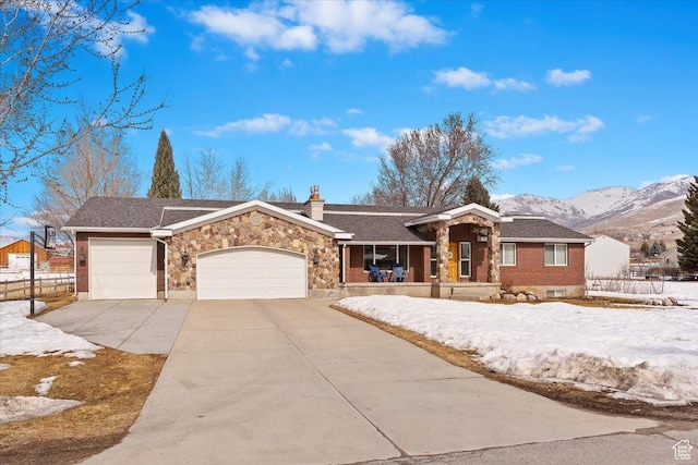 4884 E 2800 N, Eden, UT 84310 - ranch-style house featuring concrete driveway, a chimney, an attached garage, a mountain view, and a porch