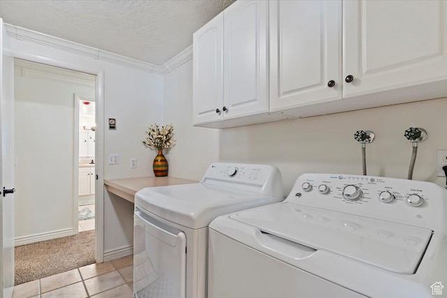 4884 E 2800 N, Eden, UT 84310 - laundry room featuring a textured ceiling, light tile patterned floors, washer and dryer, ornamental molding, and cabinet space