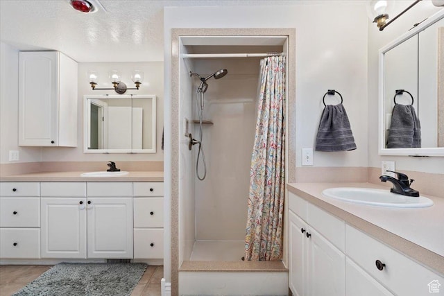 4884 E 2800 N, Eden, UT 84310 - bathroom featuring a stall shower, two vanities, and a sink