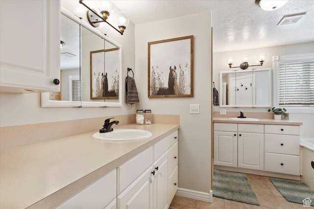 4884 E 2800 N, Eden, UT 84310 - full bathroom with a textured ceiling, visible vents, two vanities, and a sink