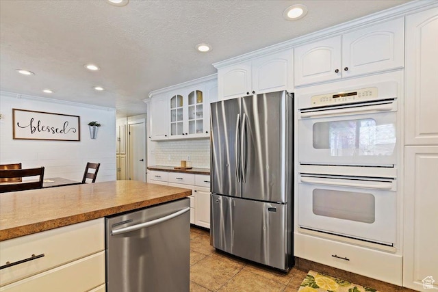 4884 E 2800 N, Eden, UT 84310 - kitchen featuring decorative backsplash, white cabinets, glass insert cabinets, appliances with stainless steel finishes, and recessed lighting