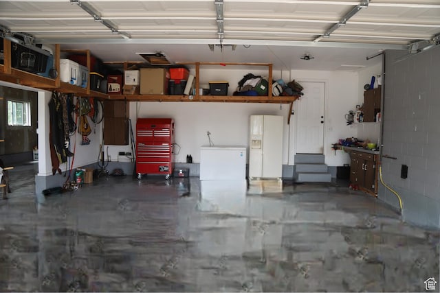 4884 E 2800 N, Eden, UT 84310 - garage featuring white fridge with ice dispenser and concrete block wall