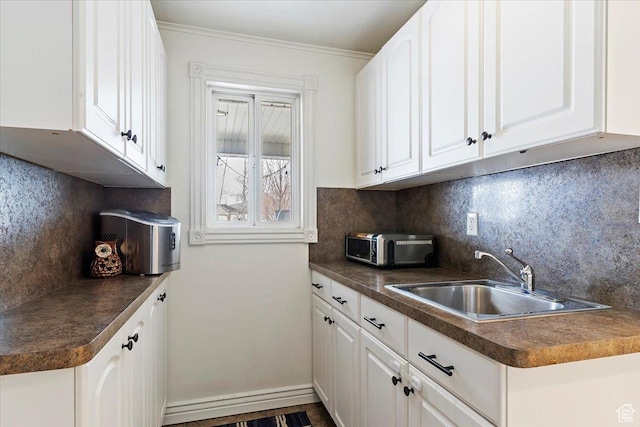 4884 E 2800 N, Eden, UT 84310 - kitchen with dark countertops, backsplash, white cabinetry, a sink, and baseboards
