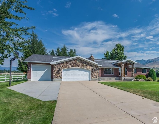 4884 E 2800 N, Eden, UT 84310 - ranch-style home with an attached garage, fence, driveway, stone siding, and a front yard