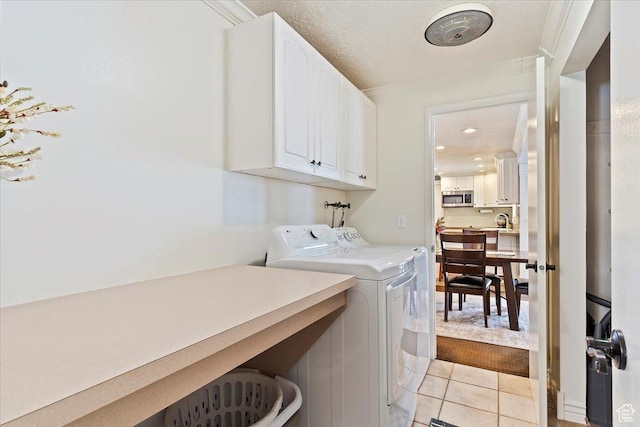 4884 E 2800 N, Eden, UT 84310 - laundry room with ornamental molding, light tile patterned flooring, cabinet space, and separate washer and dryer