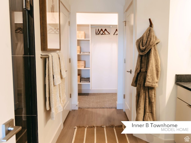 mudroom with light wood finished floors and baseboards