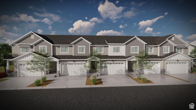 view of front facade with driveway, an attached garage, and board and batten siding