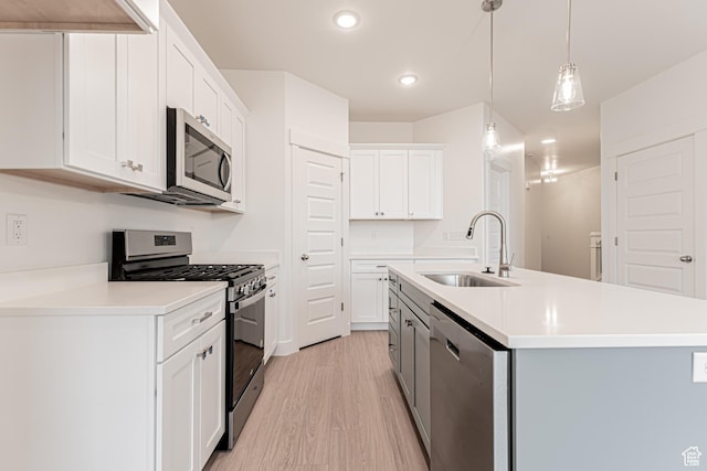 684 W 4500 S Unit 313, Mapleton, UT 84664 - kitchen with stainless steel appliances, light wood-type flooring, recessed lighting, light countertops, and an island with sink