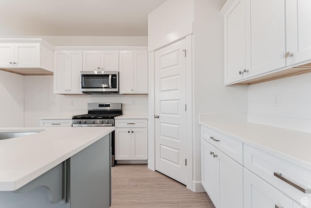 684 W 4500 S Unit 313, Mapleton, UT 84664 - kitchen featuring stainless steel appliances, light countertops, and white cabinetry