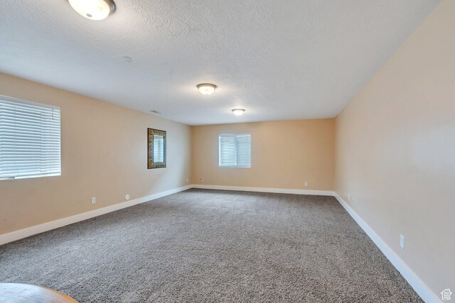 80 Pheasant, Elk Ridge, UT 84651 - carpeted spare room with a textured ceiling and baseboards