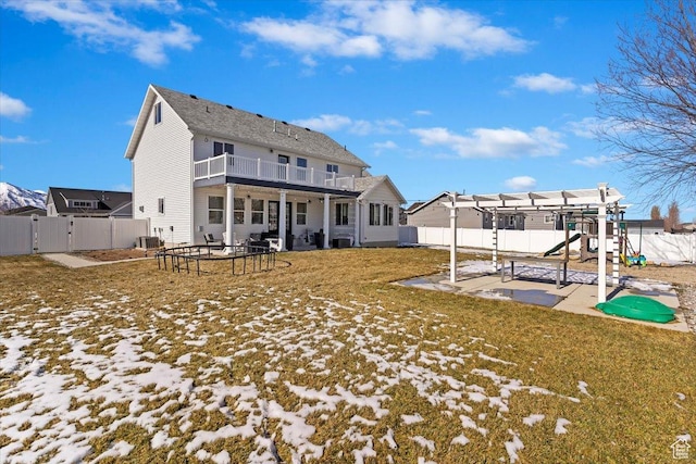 2588 S 1000 W, Nibley, UT 84321 - back of property featuring a playground, a gate, a patio area, central air condition unit, and a balcony