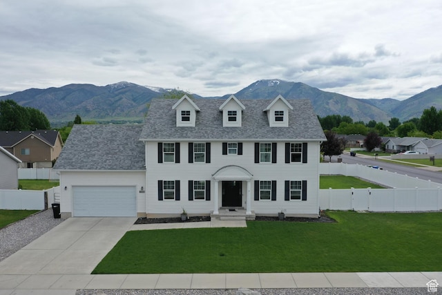 2588 S 1000 W, Nibley, UT 84321 - colonial house with a garage, a mountain view, concrete driveway, and a shingled roof