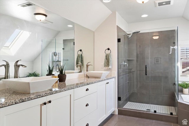 2588 S 1000 W, Nibley, UT 84321 - full bathroom with lofted ceiling, a stall shower, a skylight, double vanity, and tile patterned floors
