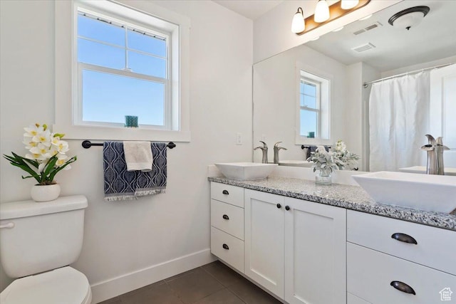 2588 S 1000 W, Nibley, UT 84321 - full bath featuring baseboards, tile patterned floors, toilet, and double vanity