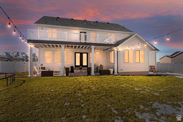 2588 S 1000 W, Nibley, UT 84321 - back of property at dusk with outdoor lounge area, a balcony, french doors, and a patio
