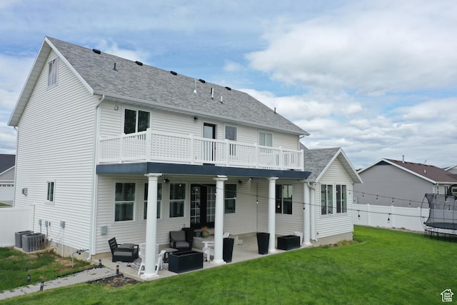 2588 S 1000 W, Nibley, UT 84321 - rear view of house featuring a trampoline, outdoor lounge area, a patio, roof with shingles, and central AC