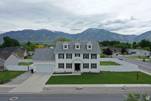 2588 S 1000 W, Nibley, UT 84321 - view of front of home featuring driveway, an attached garage, a mountain view, and a residential view