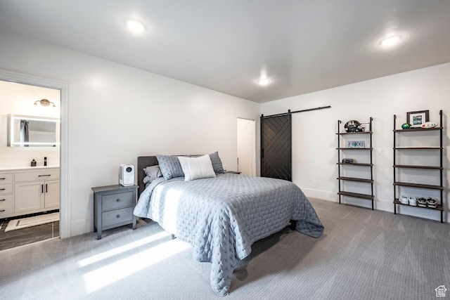 carpeted bedroom featuring recessed lighting, connected bathroom, baseboards, and a barn door