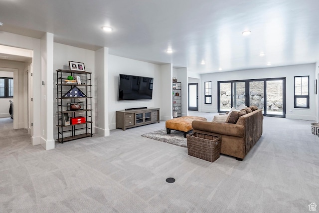 carpeted living area featuring recessed lighting and baseboards