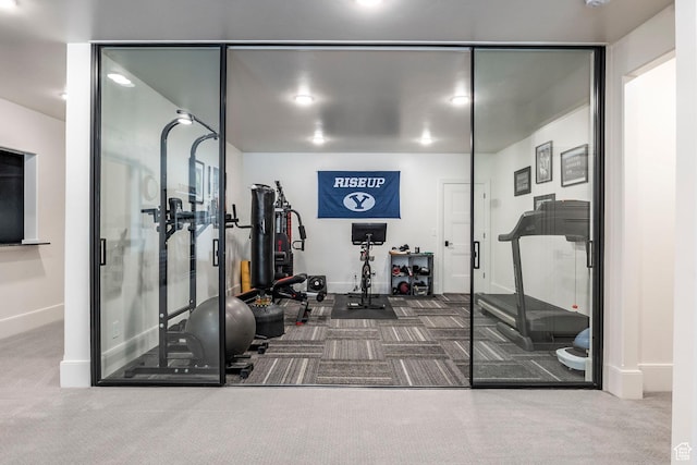workout area with baseboards and carpet flooring