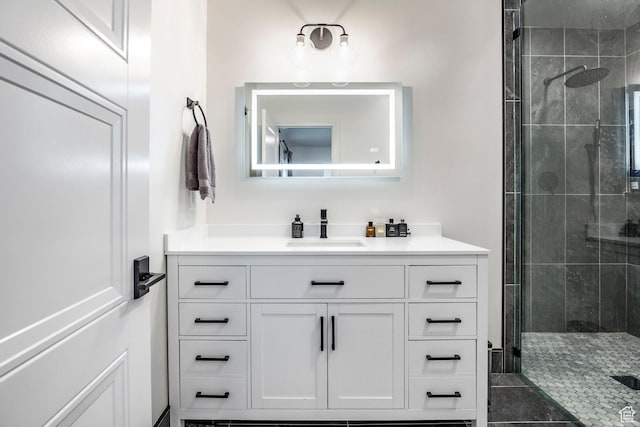 bathroom with a stall shower and vanity