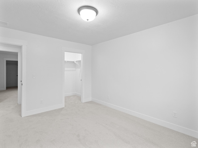 1171 W 800 S Unit 38, Spanish Fork, UT 84660 - unfurnished bedroom featuring a spacious closet, a closet, baseboards, and light carpet