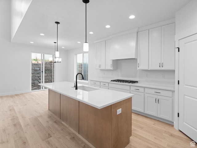 1171 W 800 S Unit 38, Spanish Fork, UT 84660 - kitchen with light wood-type flooring, a sink, white cabinetry, and premium range hood