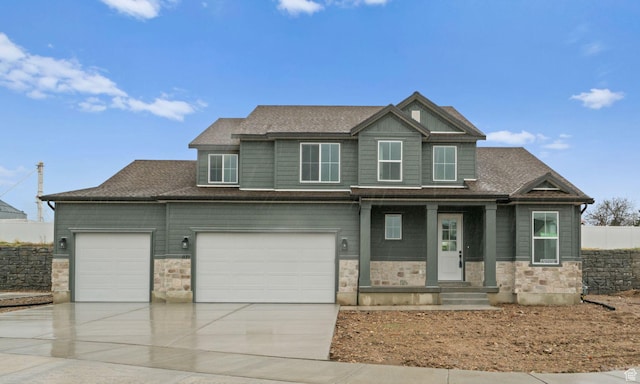 1171 W 800 S Unit 38, Spanish Fork, UT 84660 - view of front of home featuring an attached garage, driveway, stone siding, and roof with shingles