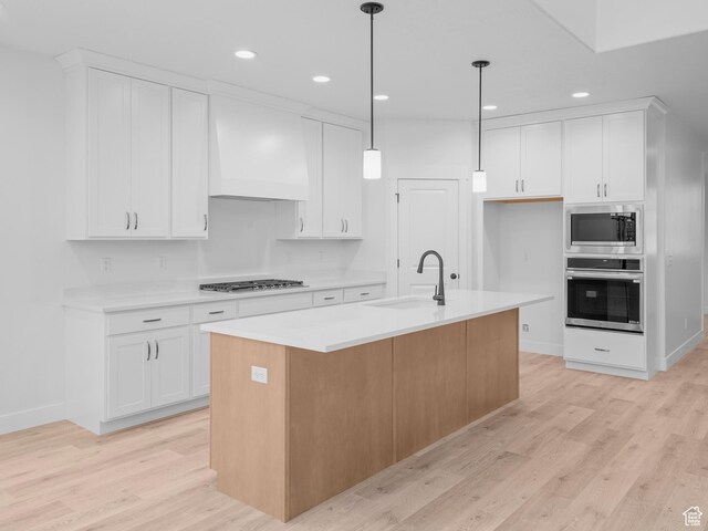 1171 W 800 S Unit 38, Spanish Fork, UT 84660 - kitchen with custom exhaust hood, appliances with stainless steel finishes, light countertops, and light wood-type flooring