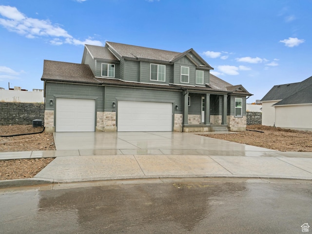 1171 W 800 S Unit 38, Spanish Fork, UT 84660 - view of front of house featuring roof with shingles, central AC unit, driveway, stone siding, and an attached garage