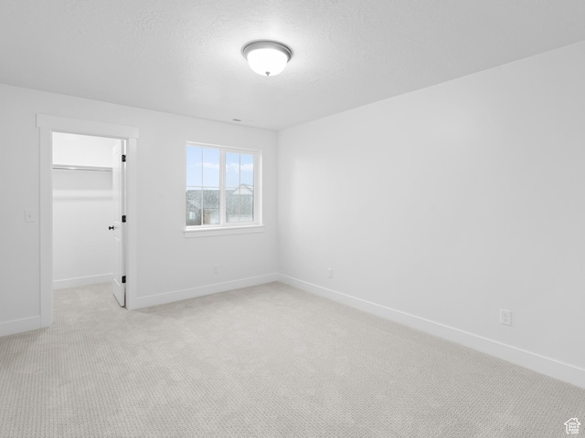 1171 W 800 S Unit 38, Spanish Fork, UT 84660 - unfurnished bedroom featuring a closet, a spacious closet, baseboards, and light carpet