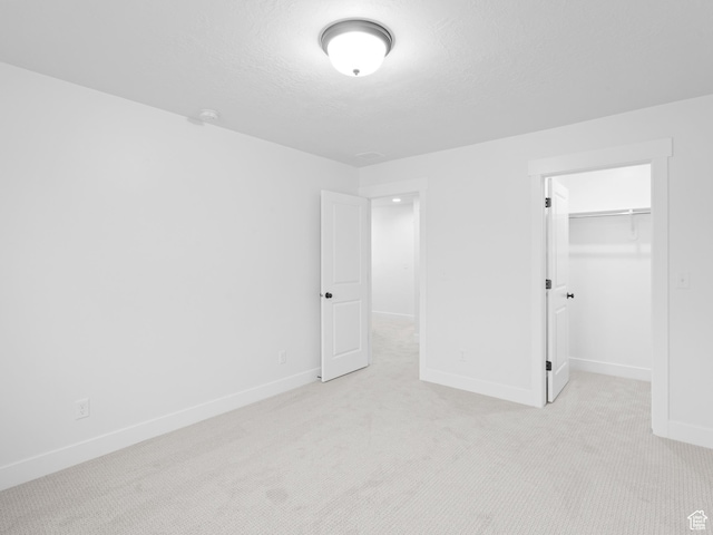 1171 W 800 S Unit 38, Spanish Fork, UT 84660 - unfurnished bedroom with a walk in closet, baseboards, and light carpet